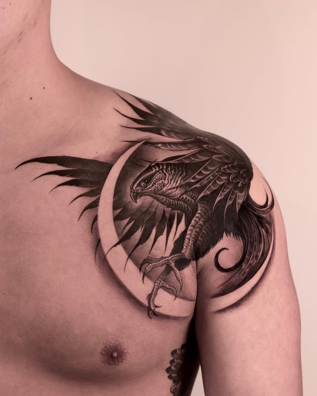 Intricate hawk tattoo design on shoulder