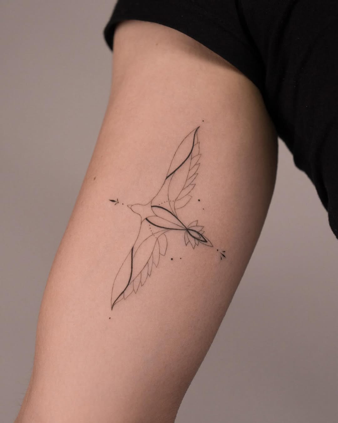 Elegant geometric hawk tattoo design.