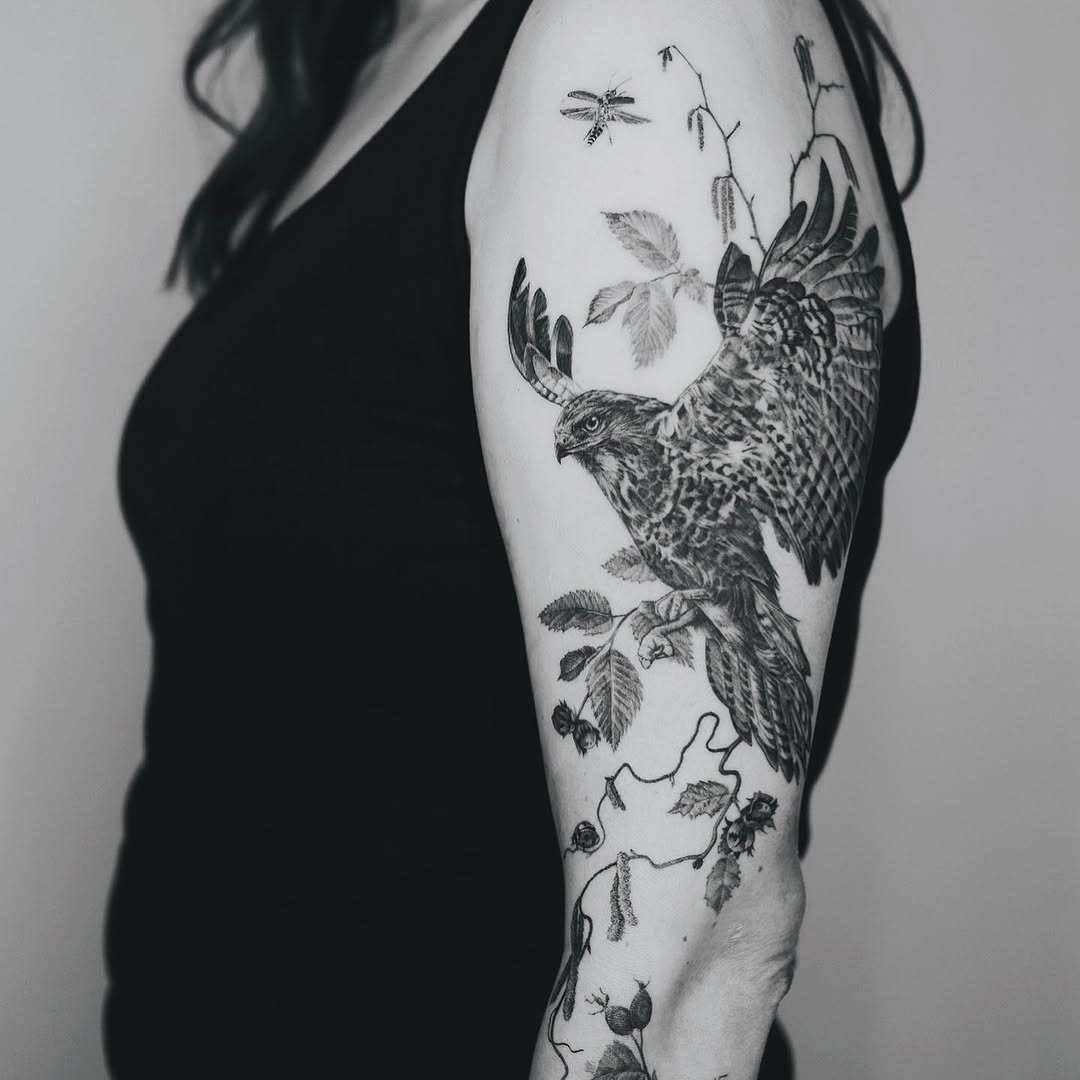 Elegant hawk tattoo with nature elements