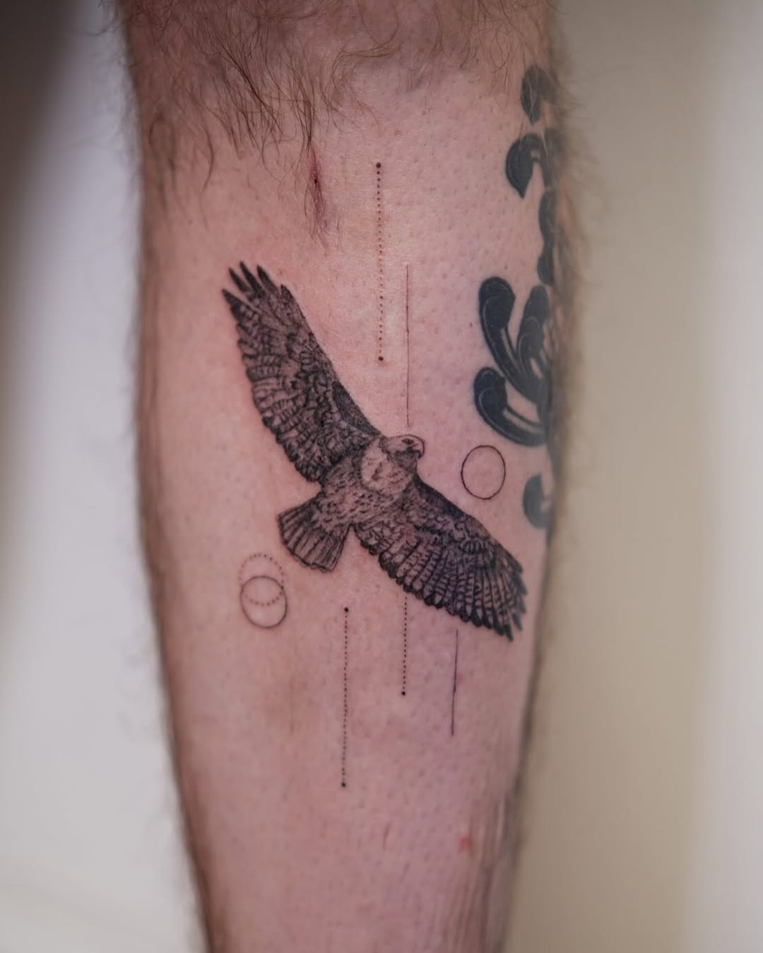 Intricate hawk tattoo in dynamic flight pose