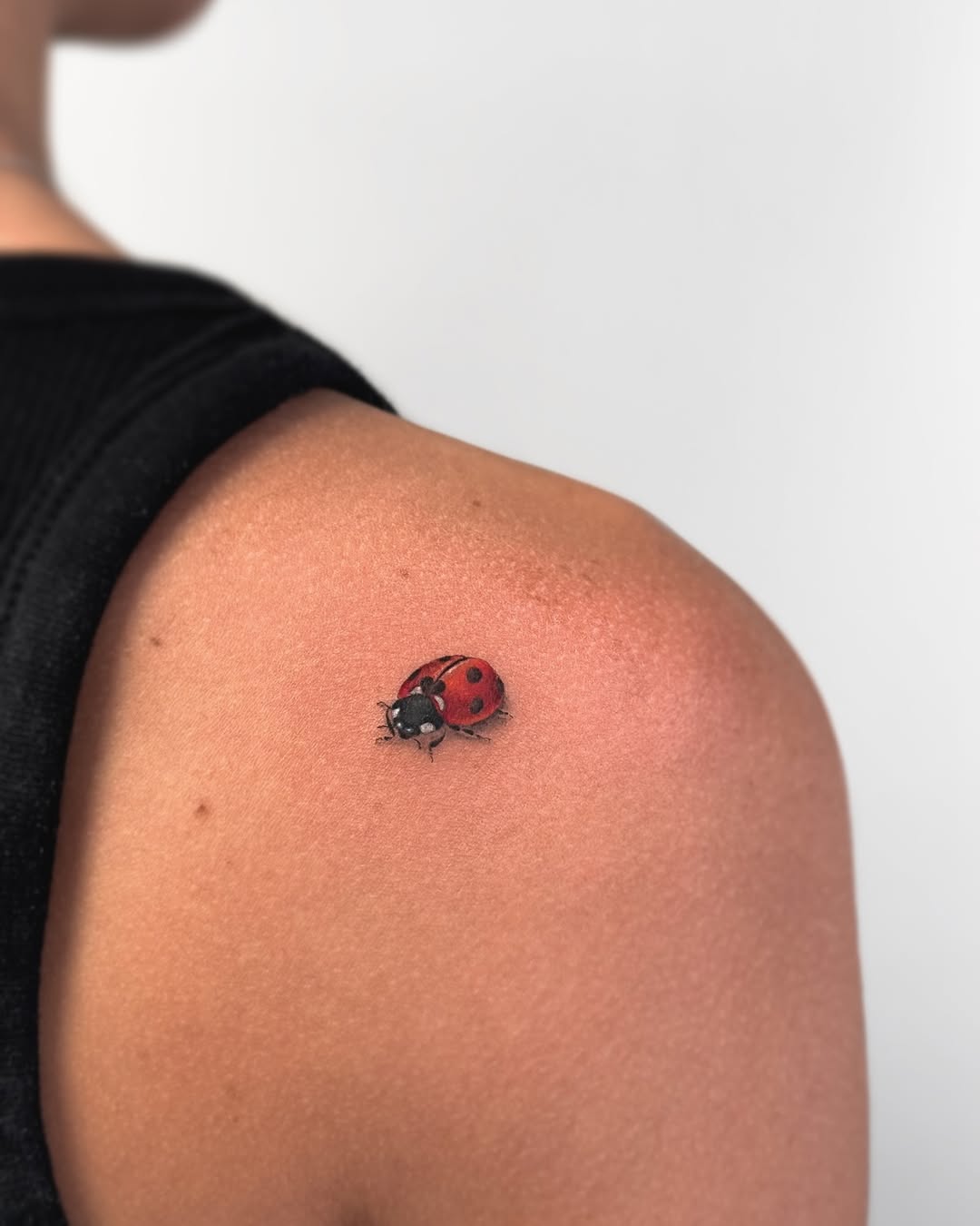 Charming ladybug tattoo on shoulder