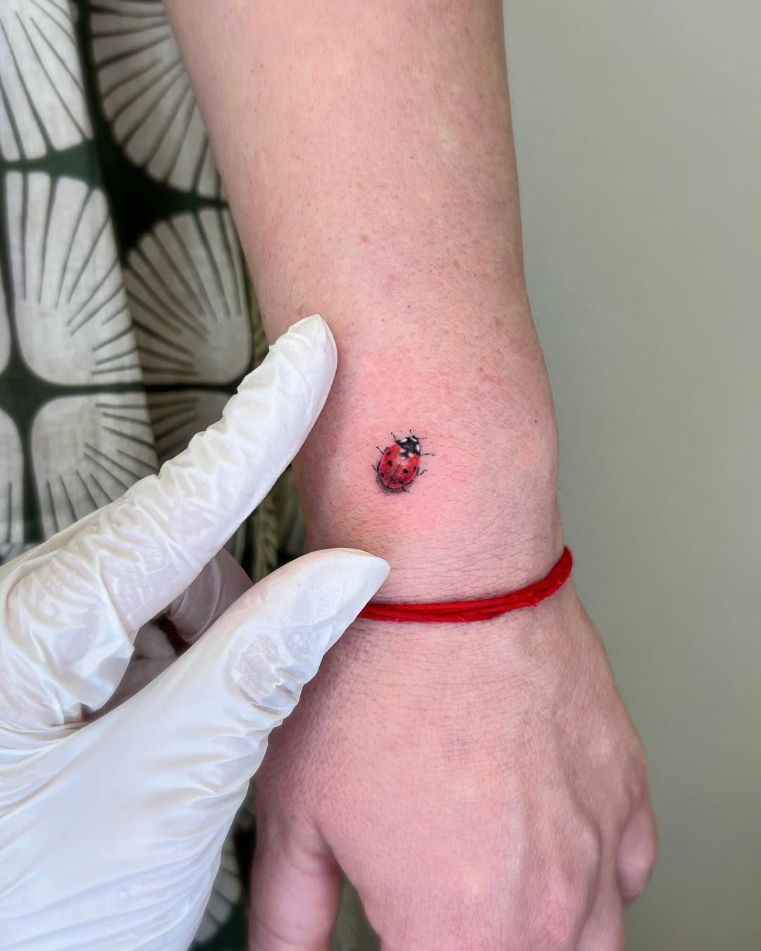Charming ladybug tattoo on the wrist