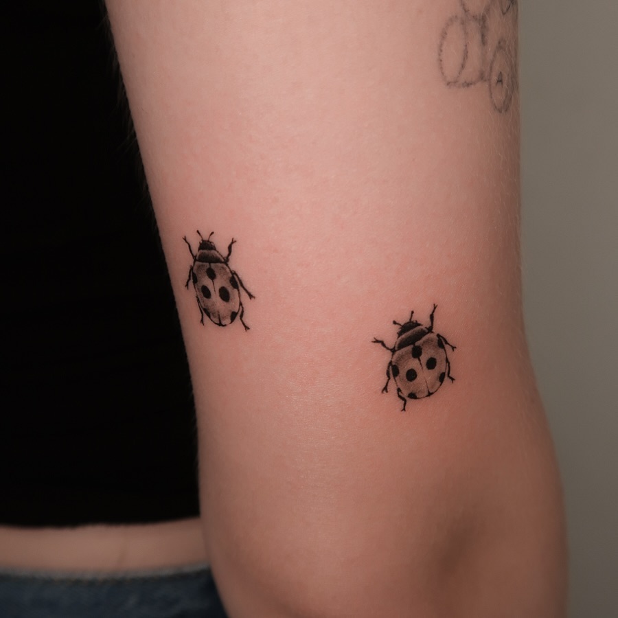 Charming minimalistic ladybug tattoo design