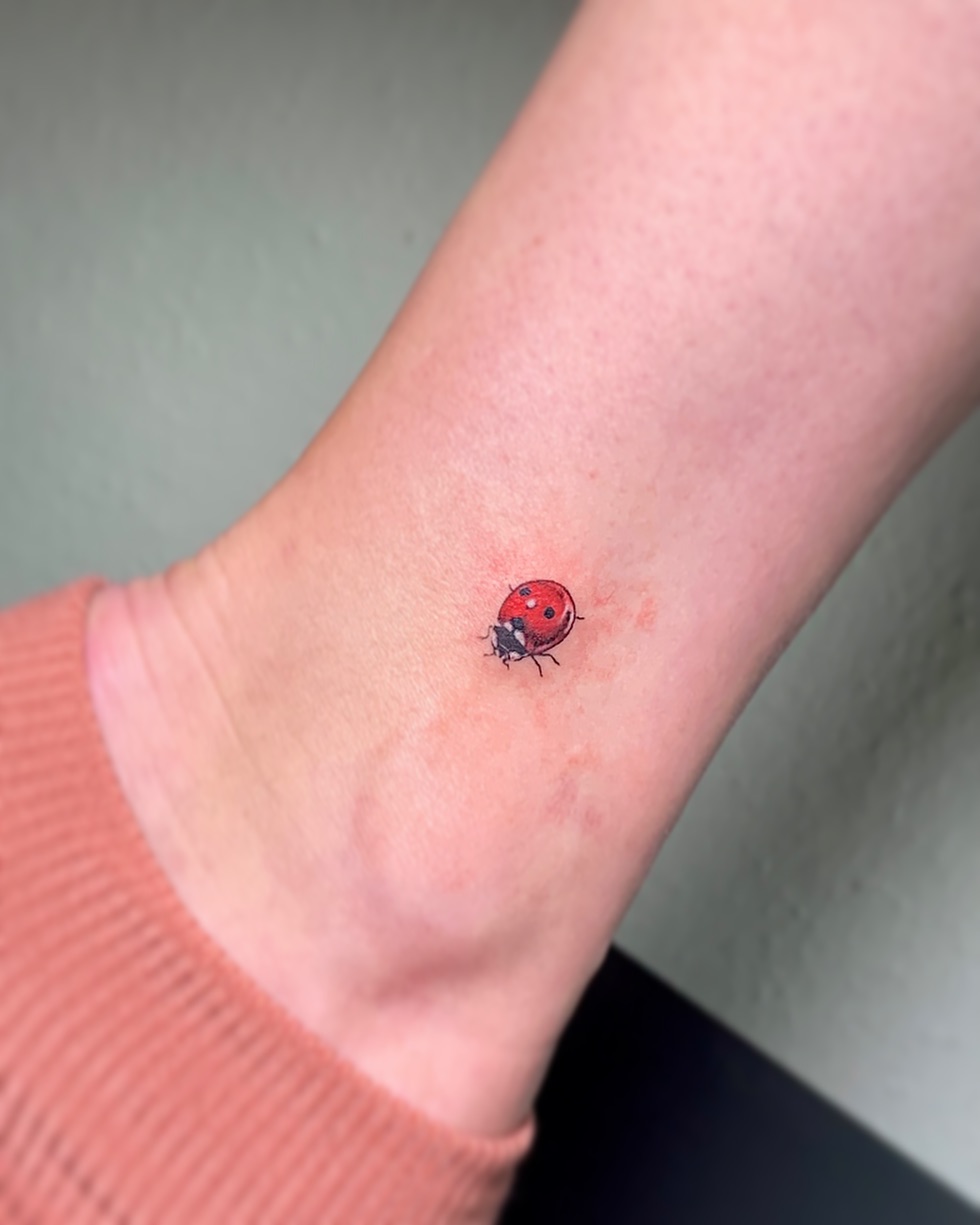 Charming ladybug tattoo design on ankle