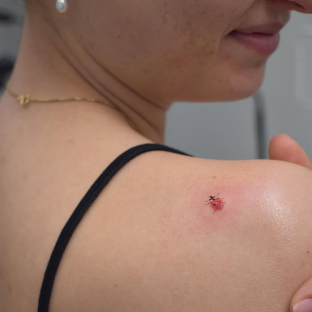 Charming ladybug tattoo on shoulder