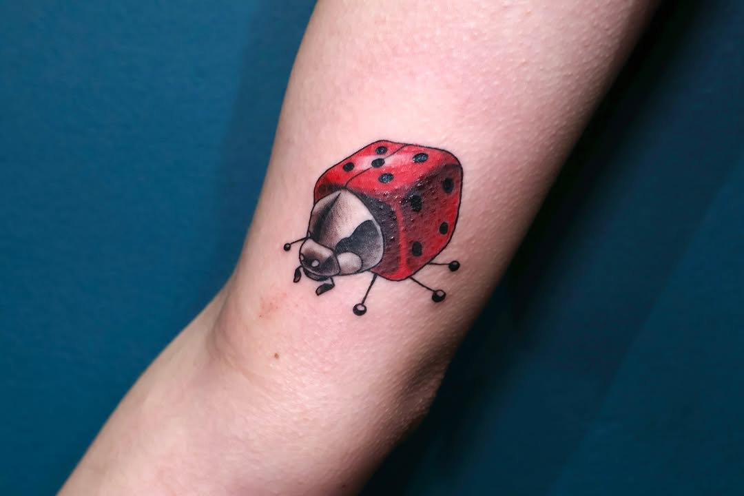 Whimsical ladybug tattoo with a playful design