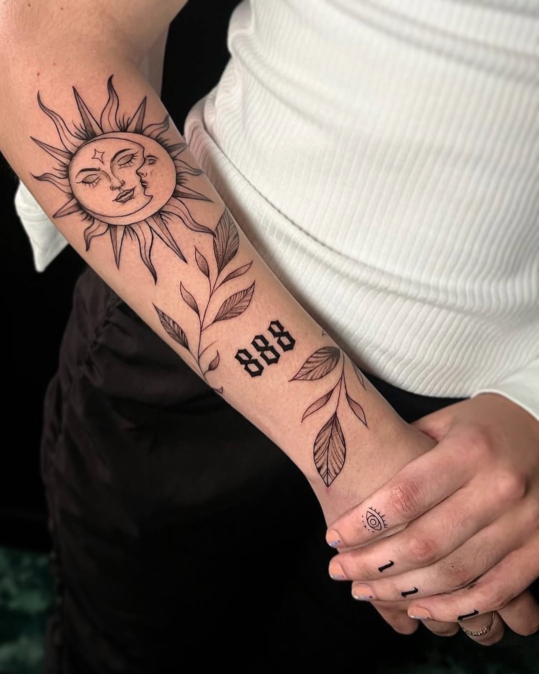 Stunning sun and moon forearm tattoo design