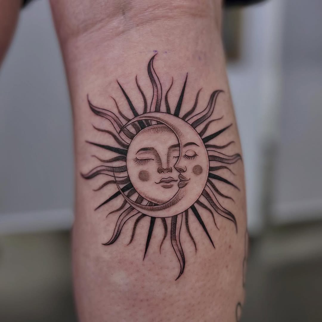 A unique sun and moon tattoo with faces.
