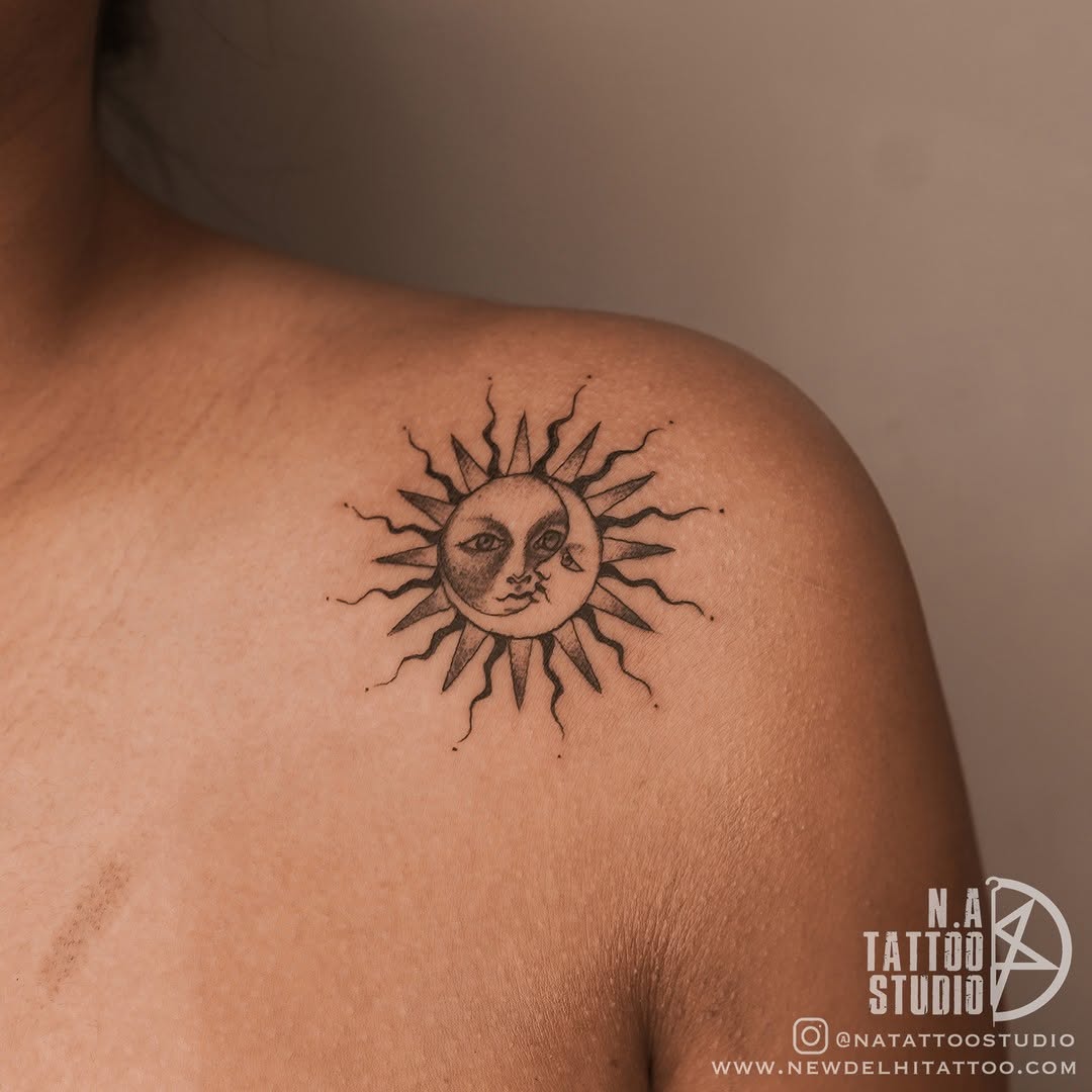 Intricate sun and moon tattoo design on shoulder