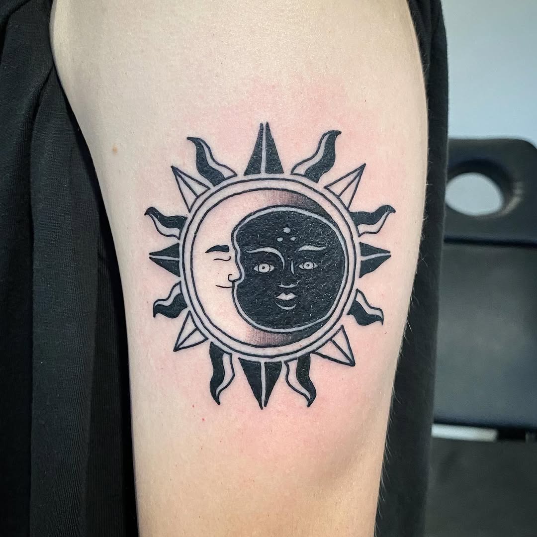 Intricate sun and moon black and white tattoo