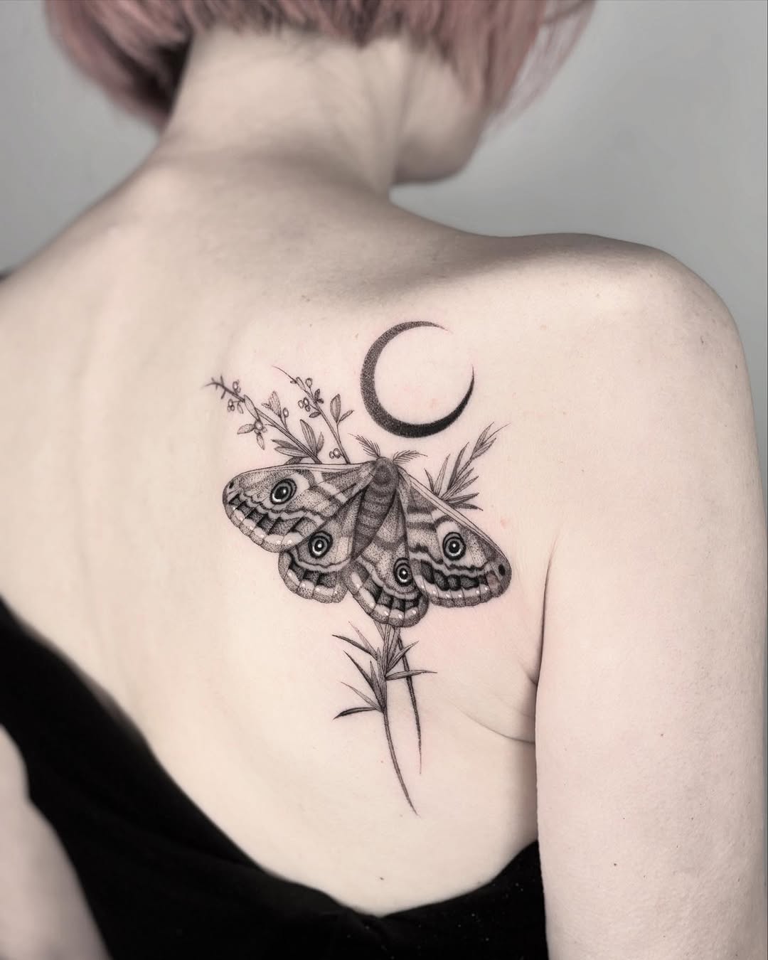 Ethereal moth tattoo with crescent moon elements