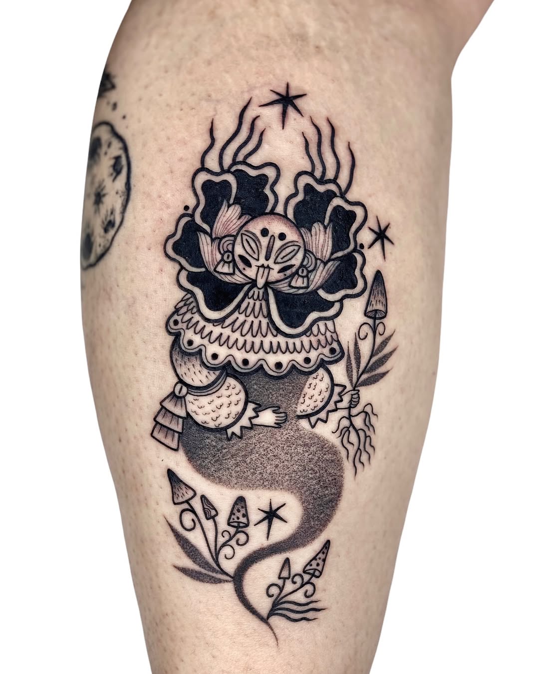 Whimsical creature in a floral design tattoo