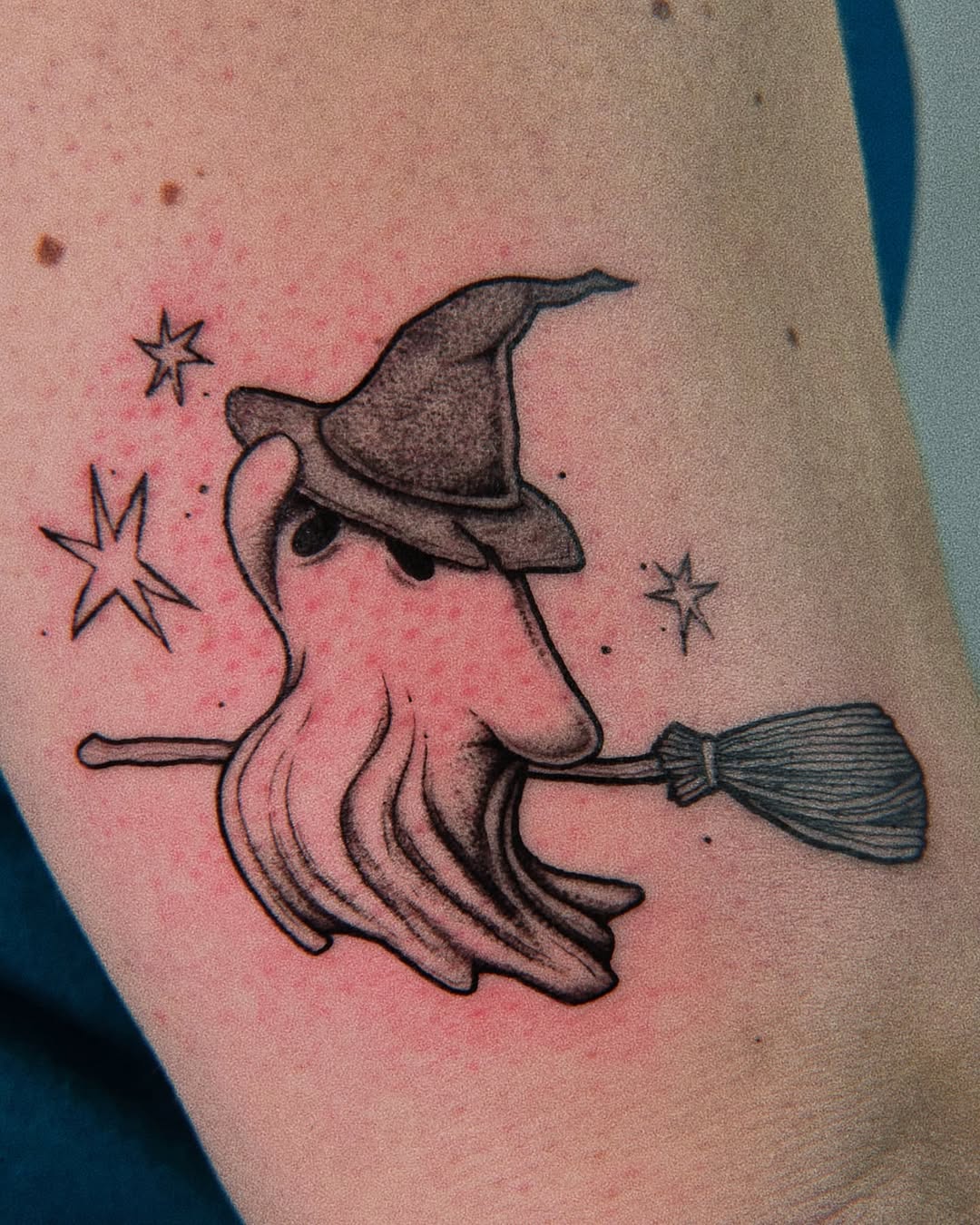 Playful ghost in a witch hat tattoo design