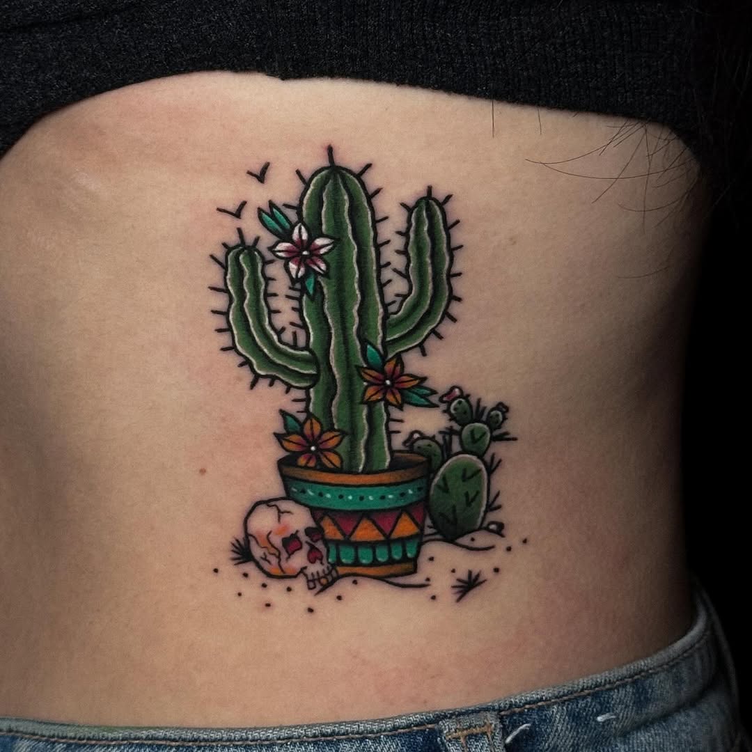 Whimsical cactus tattoo with skull accent