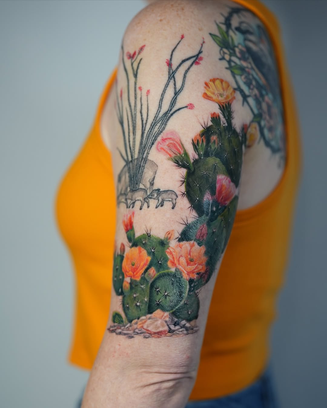 Vibrant cactus tattoo showcasing blooming flowers