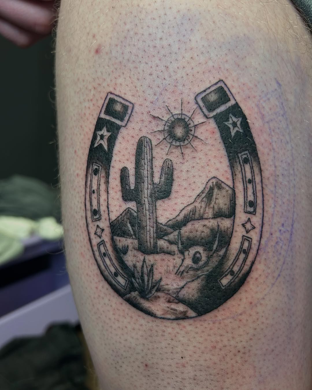 Cactus and horseshoe tattoo with a sunset vibe