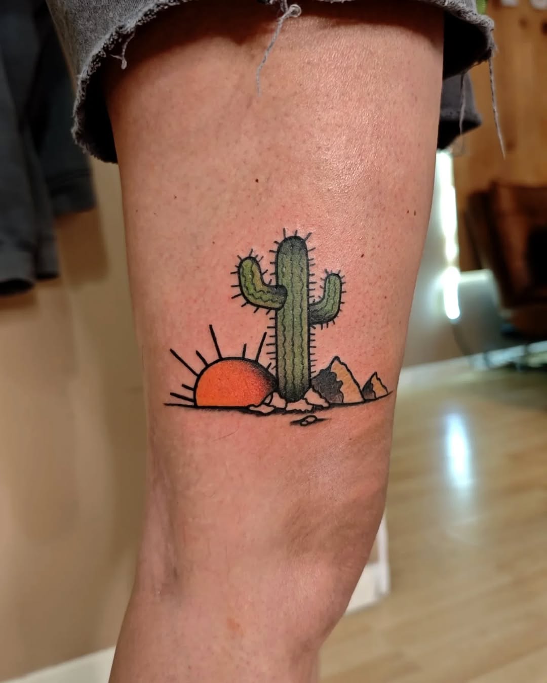 Charming cactus tattoo with a sunset vibe