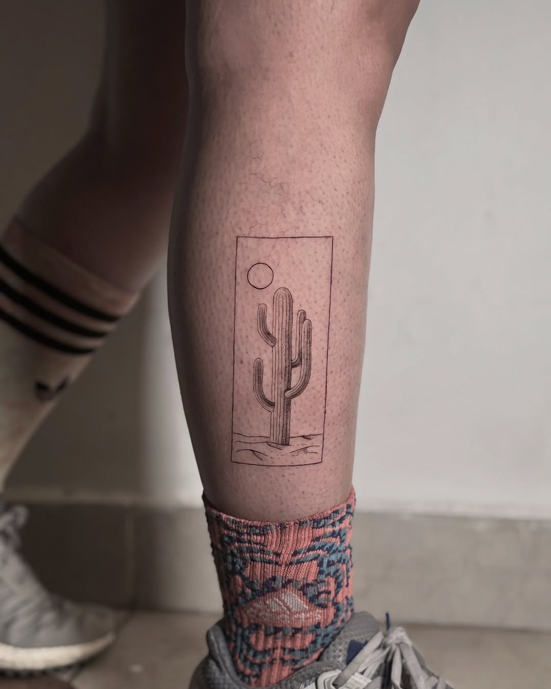 Stylish minimalist cactus tattoo on the leg