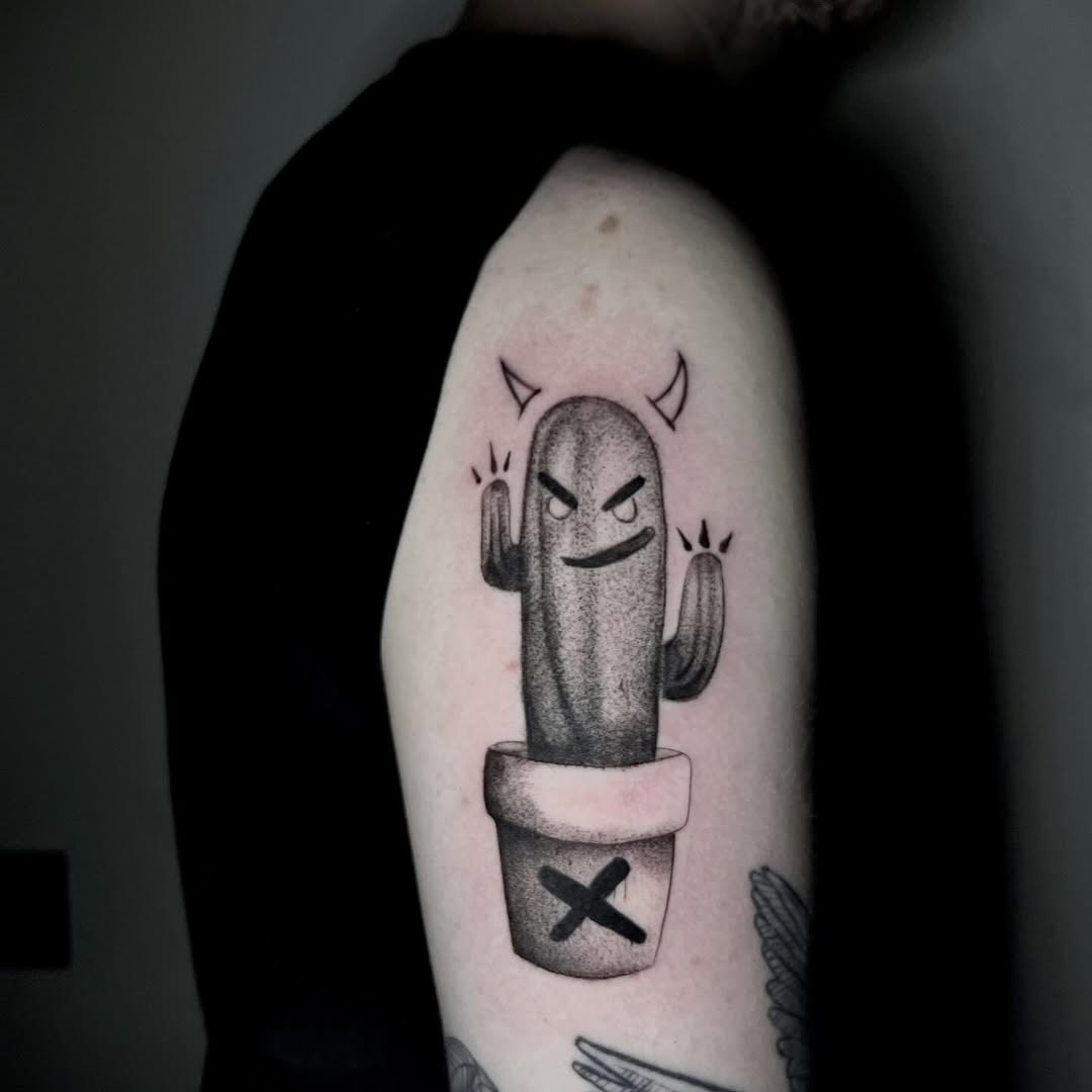 Whimsical cactus tattoo with a quirky expression