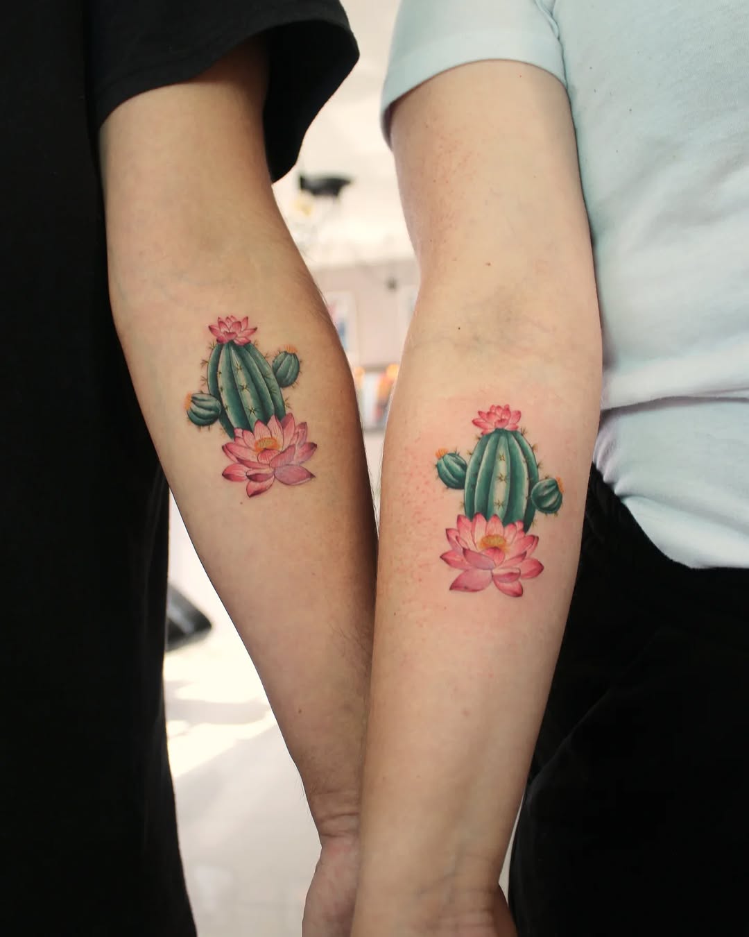 Vibrant cactus tattoo designs on arms