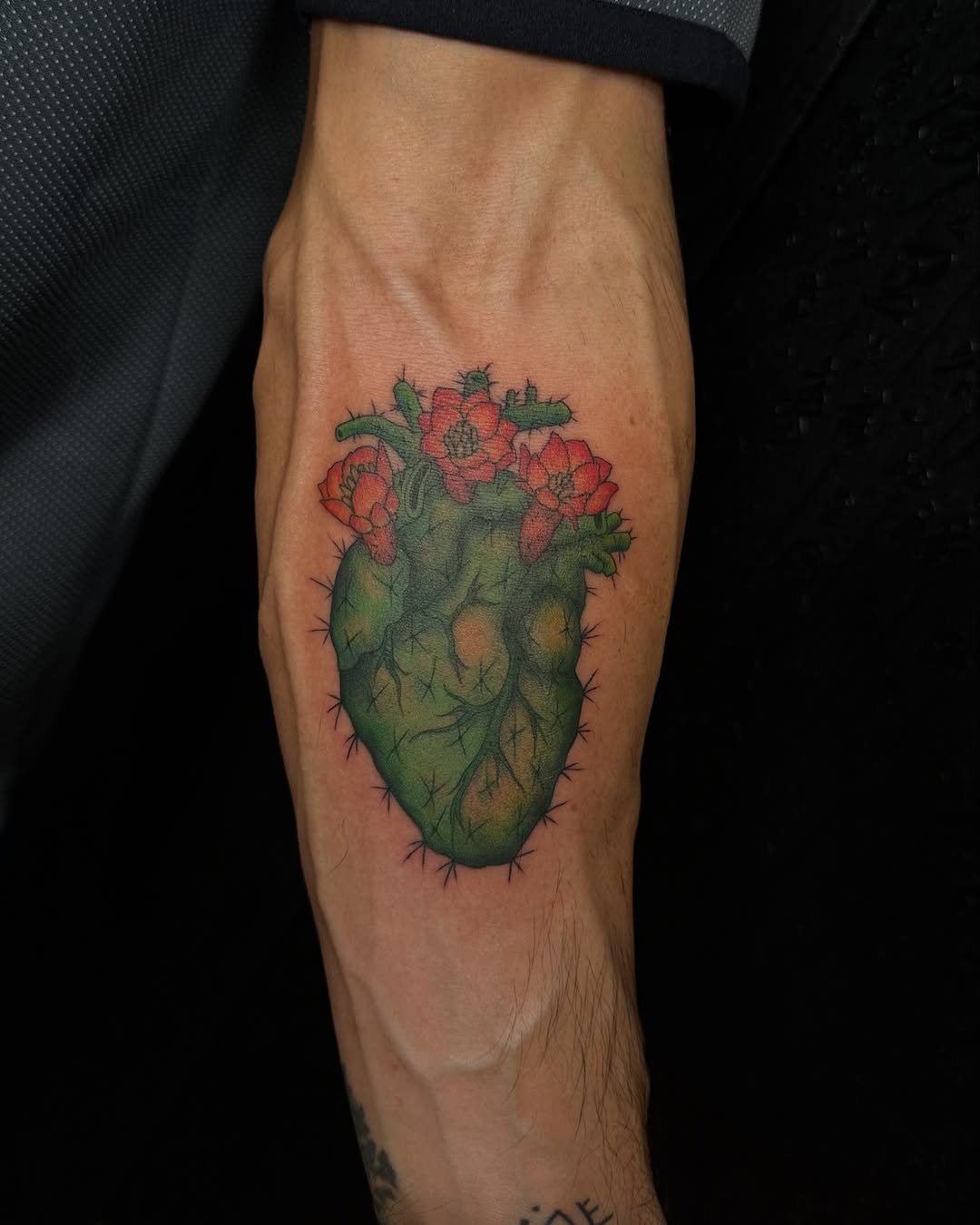 Vibrant cactus heart tattoo with flowers