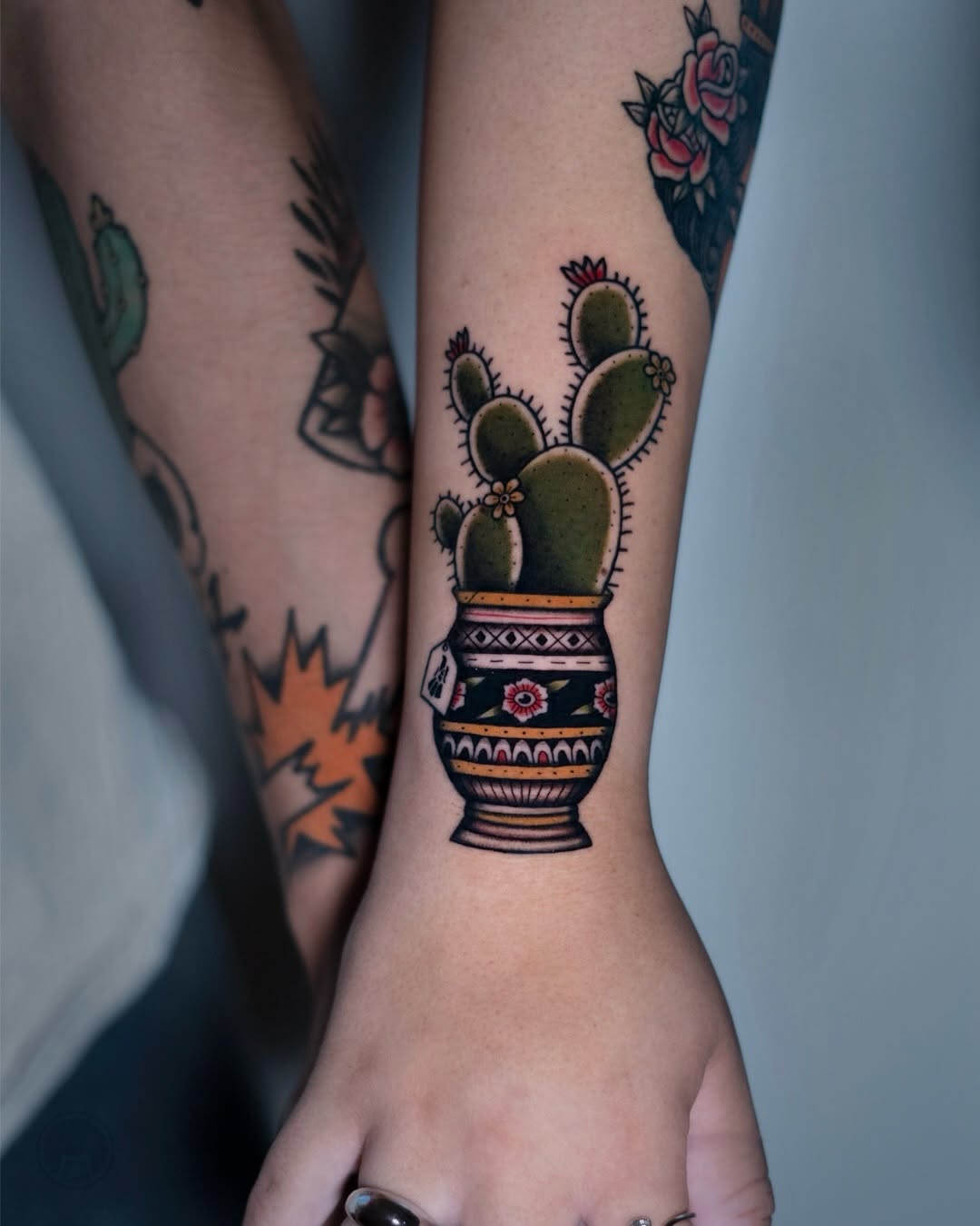 Charming cactus tattoo in a decorative pot