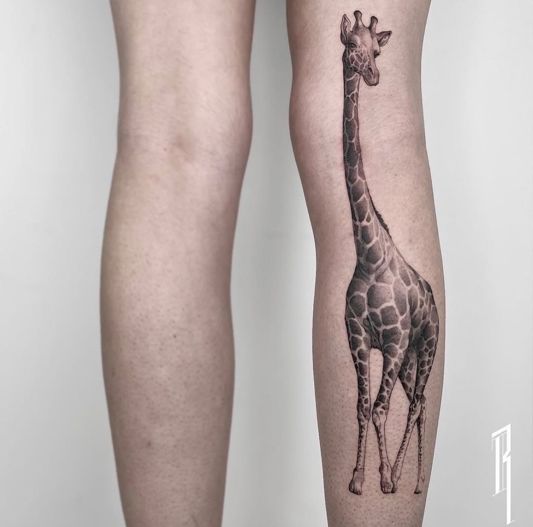 Elegant giraffe tattoo on calf showcases artistry