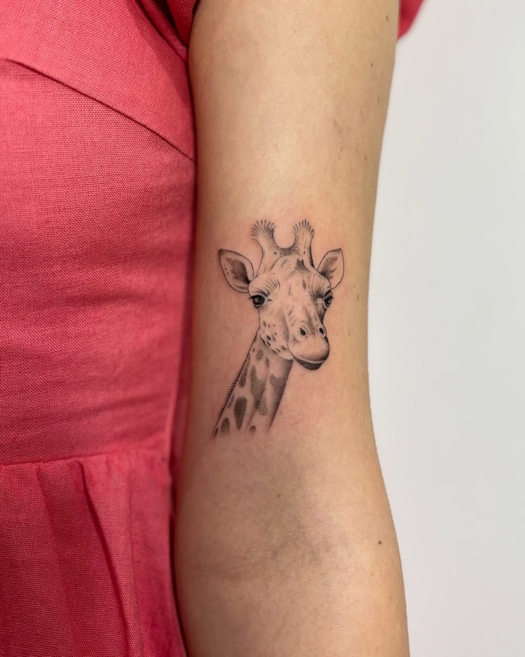Charming Giraffe Tattoo on Arm for Animal Lovers