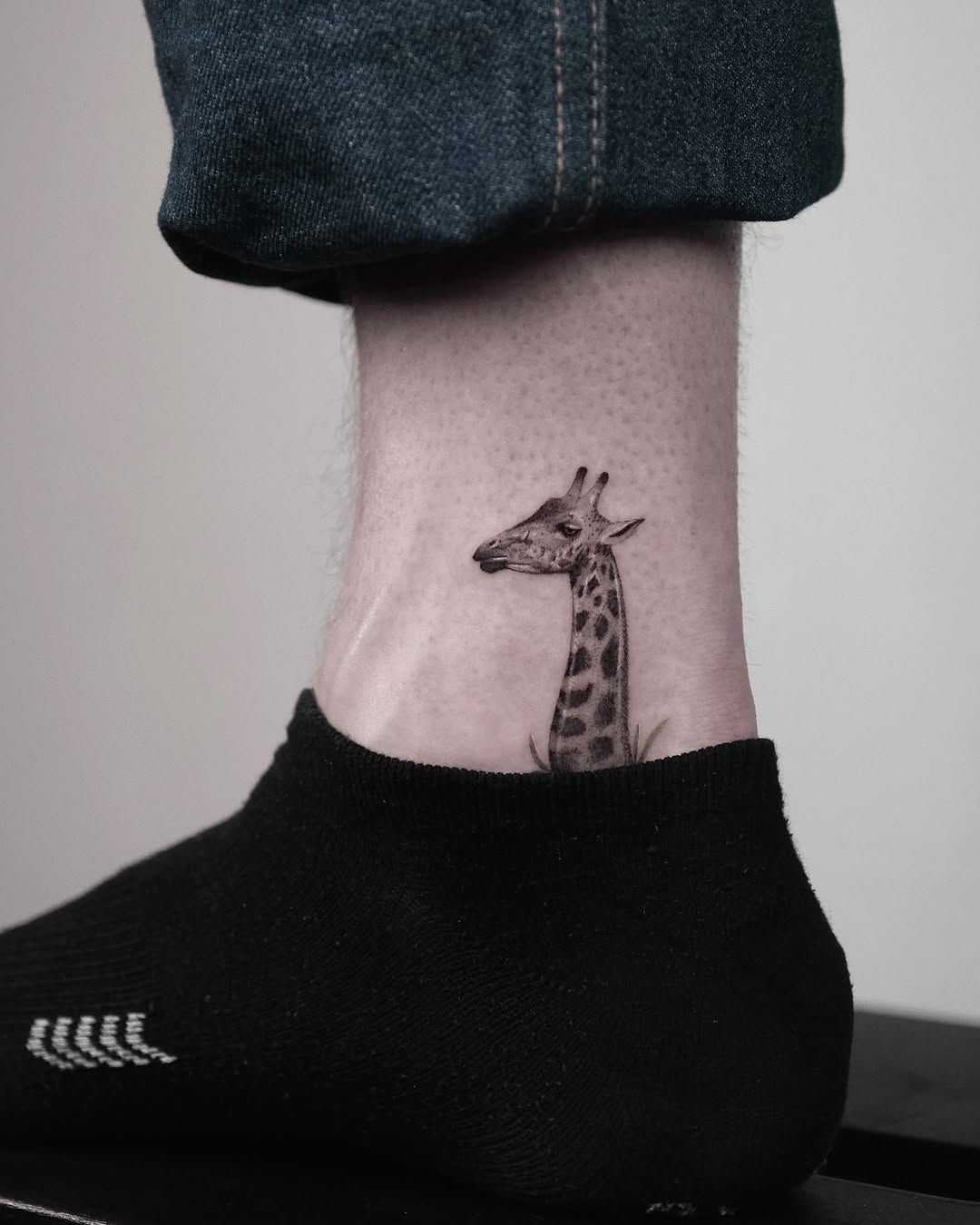 Unique giraffe tattoo on ankle