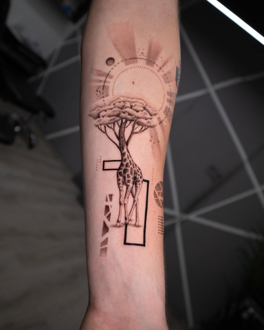 Elegant giraffe tattoo with tree elements