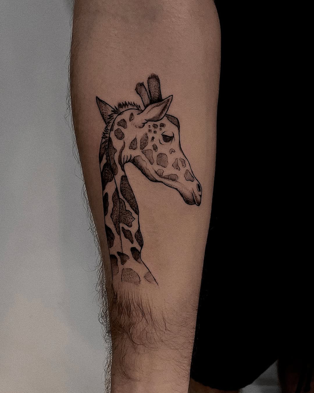 Stunning giraffe head tattoo in black ink