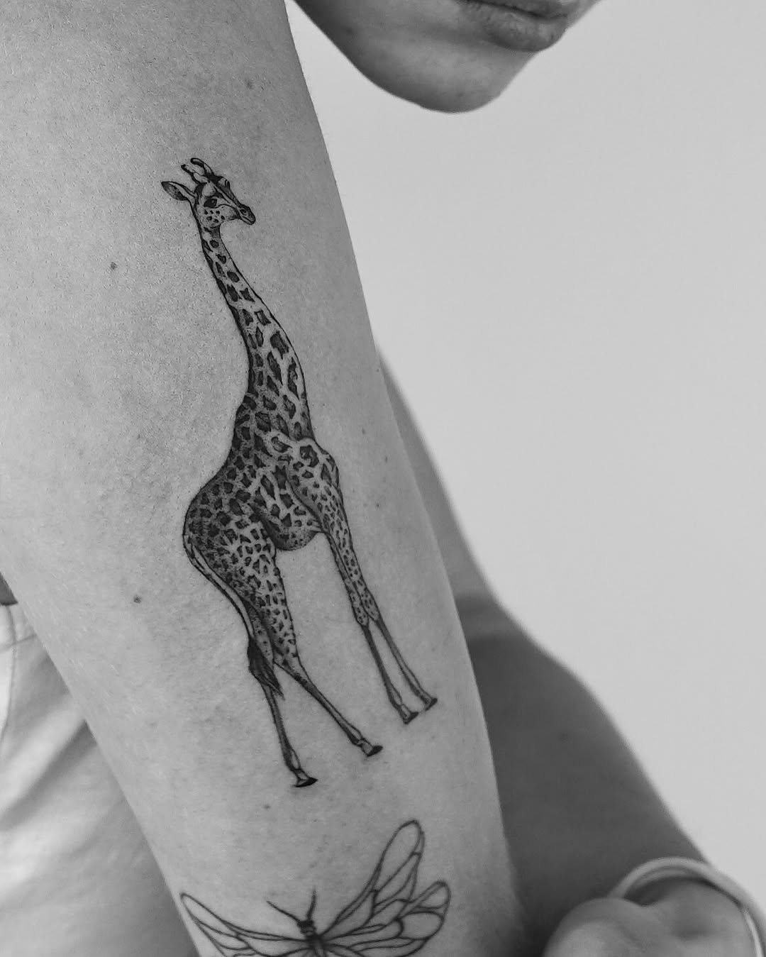 Stylish giraffe tattoo on a person's arm