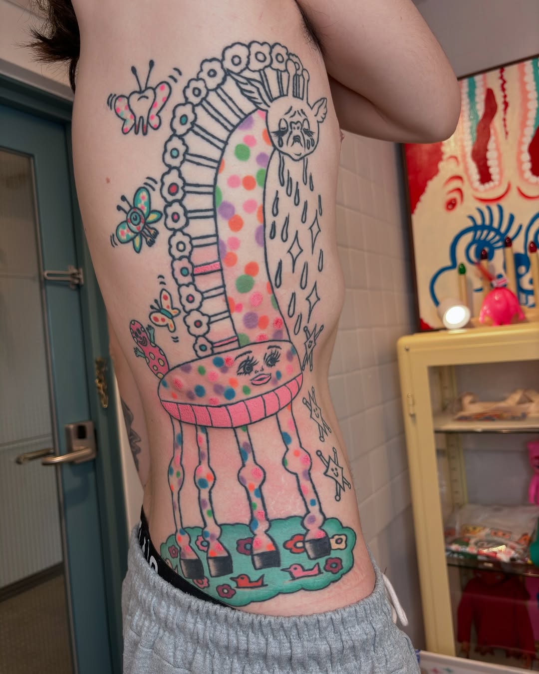 Whimsical Giraffe Tattoo with Playful Elements