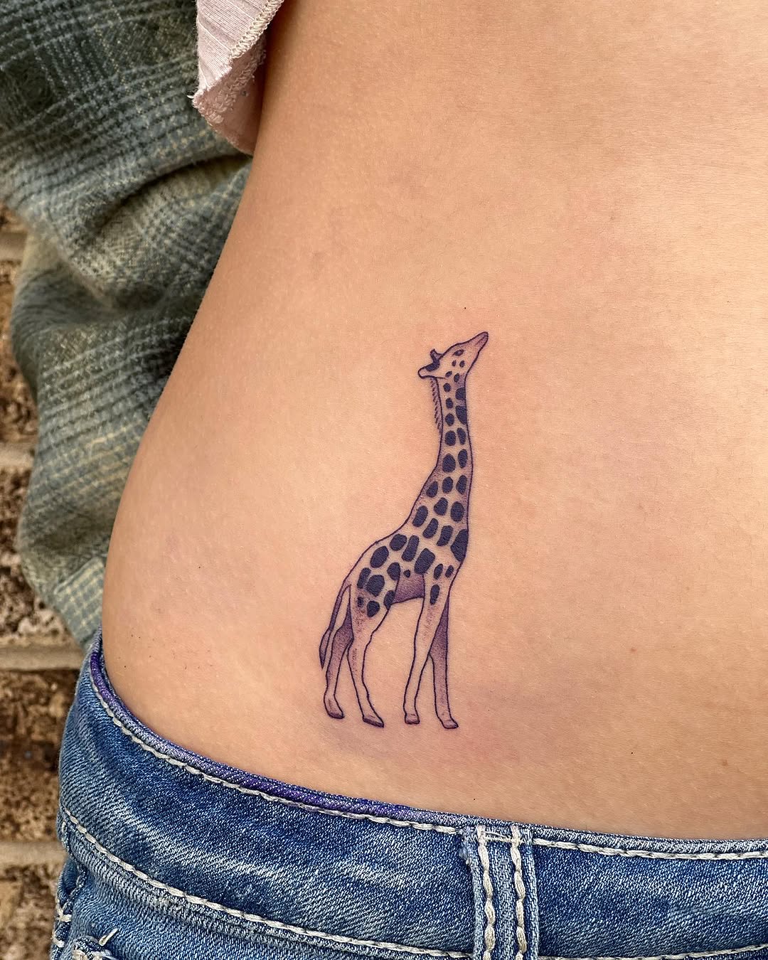 Charming giraffe tattoo on the side body