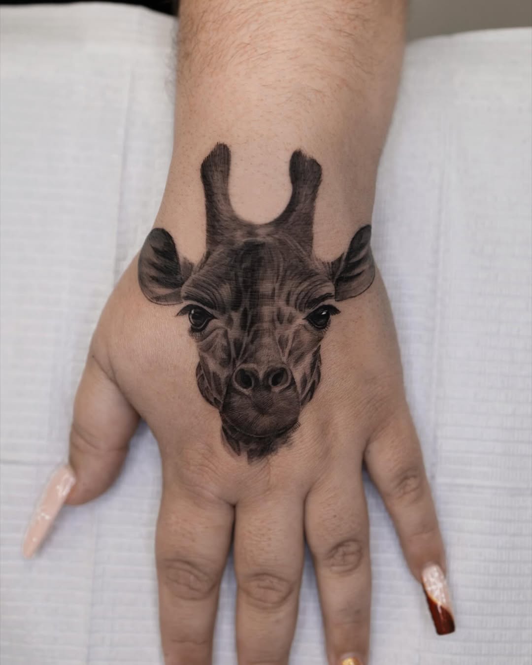 Realistic Giraffe Tattoo on the Hand