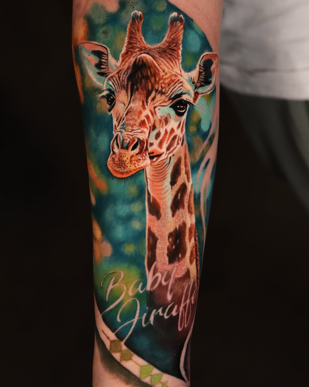 Whimsical baby giraffe tattoo with vibrant colors