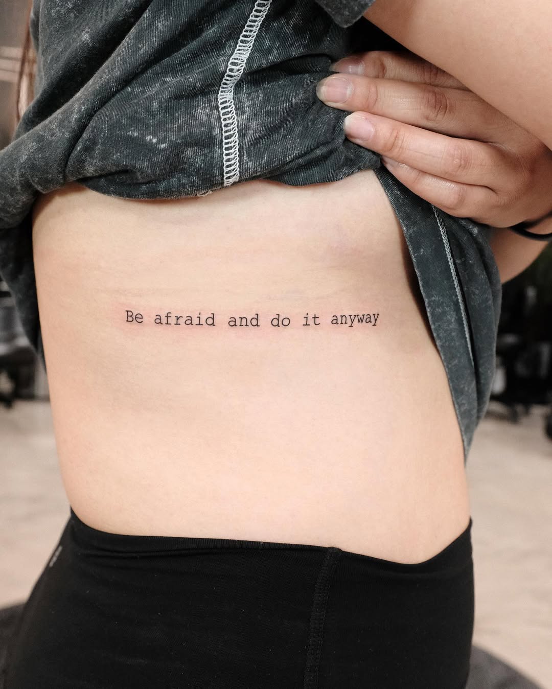 Inspiring quote tattoo on rib cage