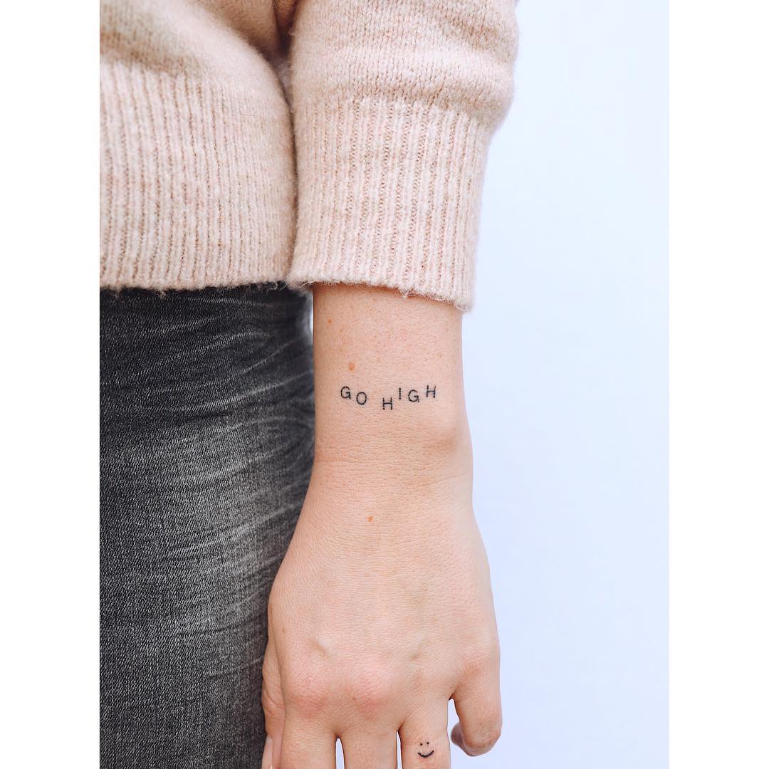 Minimalist tattoo featuring an inspiring quote