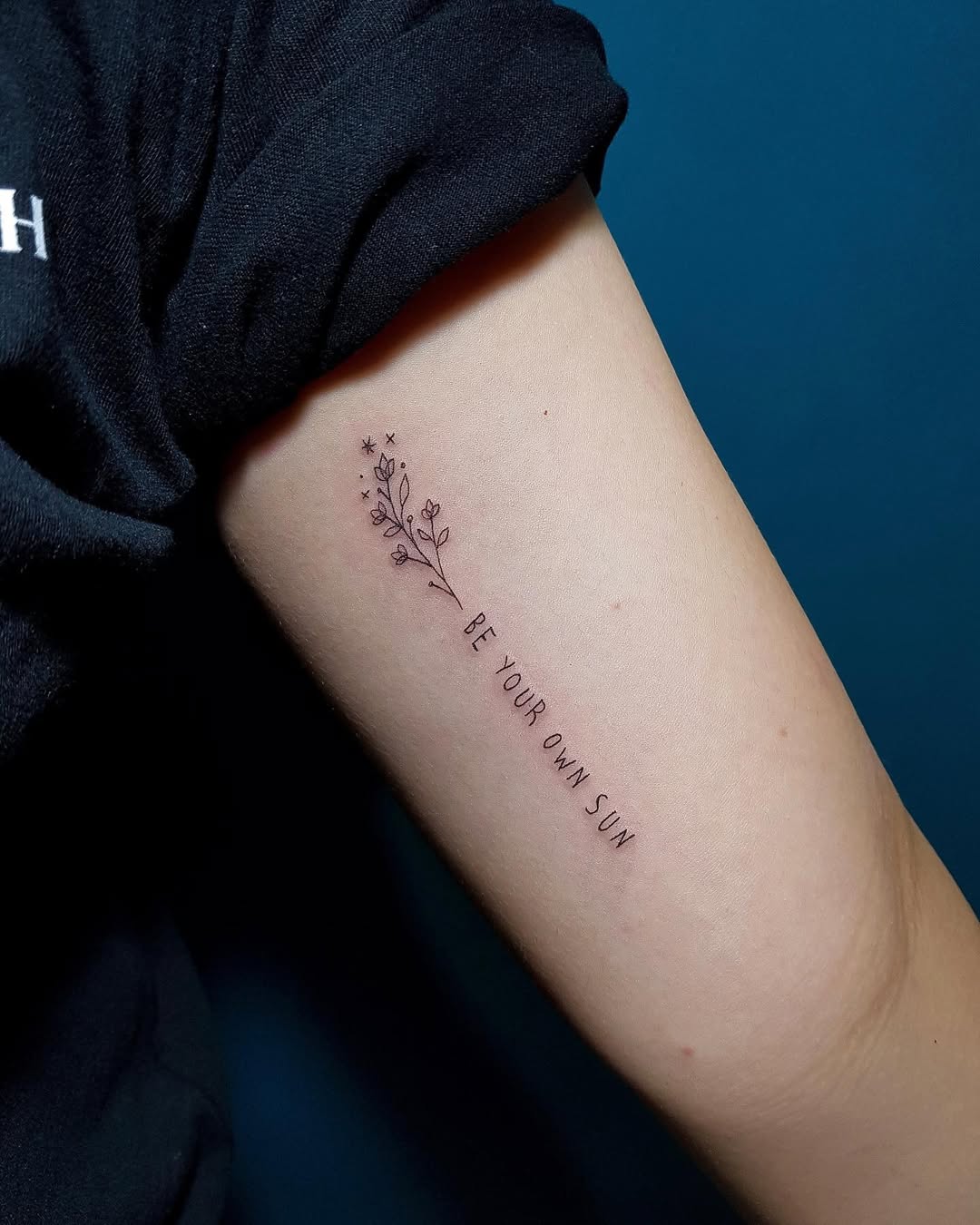 Inspiring flower quote tattoo on the arm