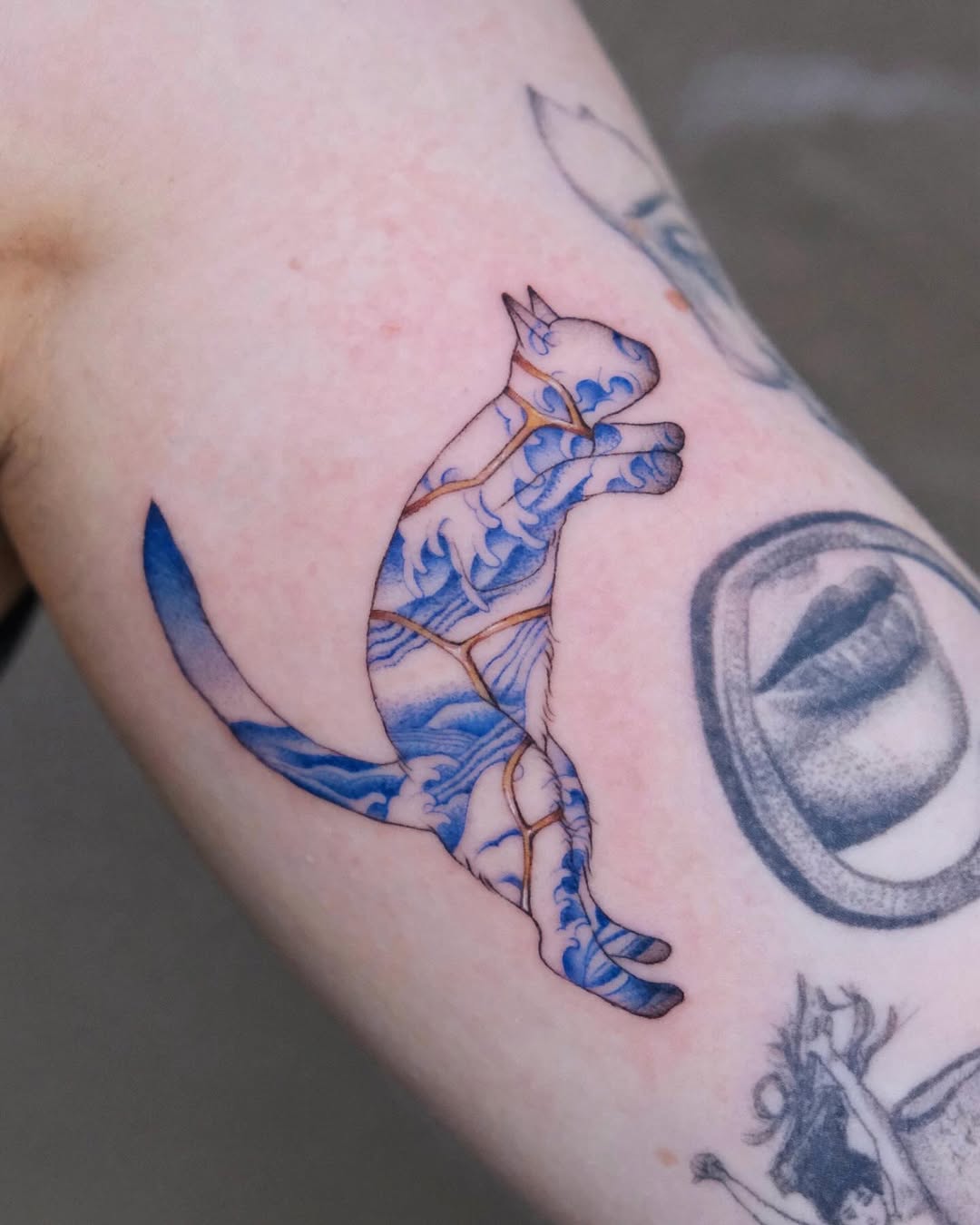 Intricate cat tattoo symbolizing resilience and beauty