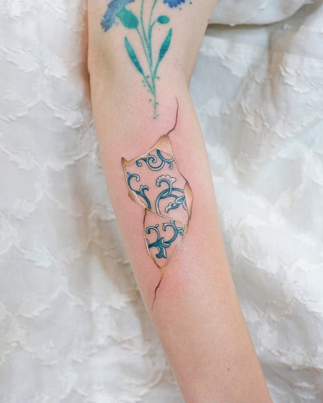 Unique kintsugi tattoo showcasing delicate floral patterns