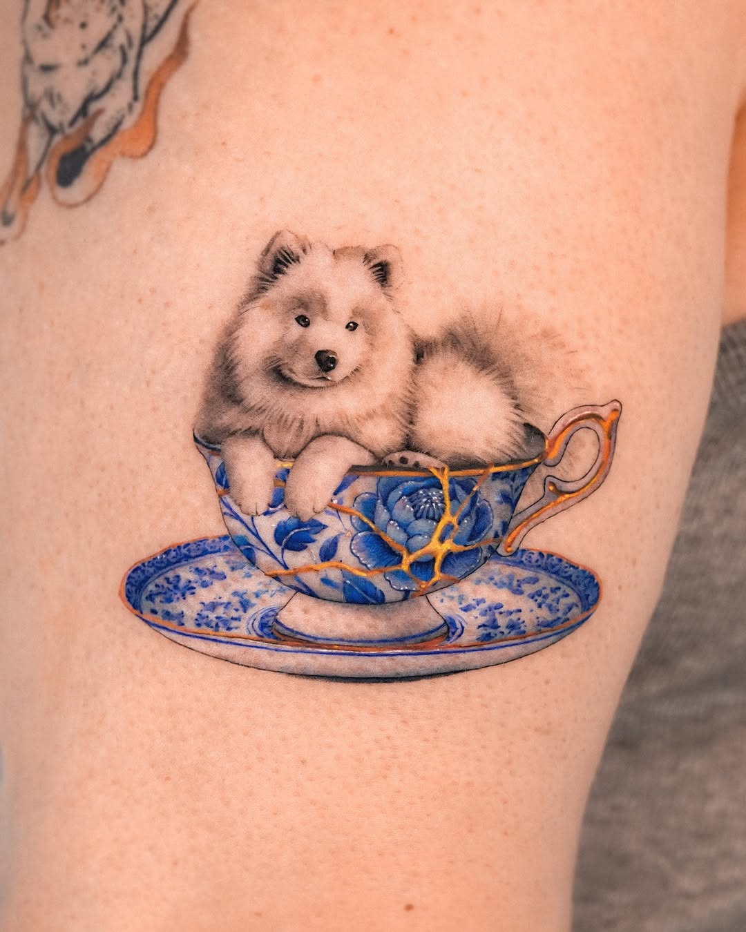 Charming samoyed in a delicate teacup tattoo