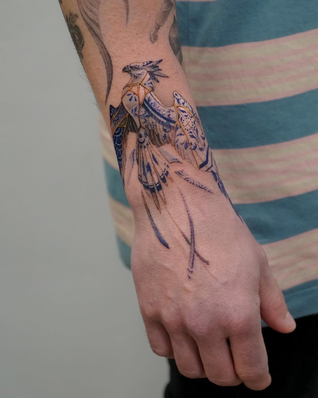 Elegant Kintsugi Bird Tattoo on Forearm