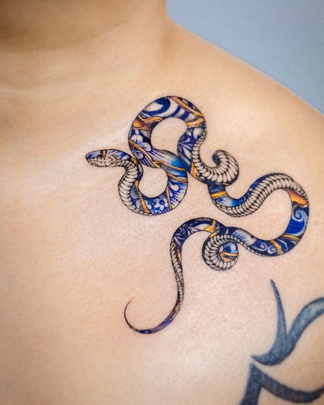 Vibrant Kintsugi Snake Tattoo on Skin