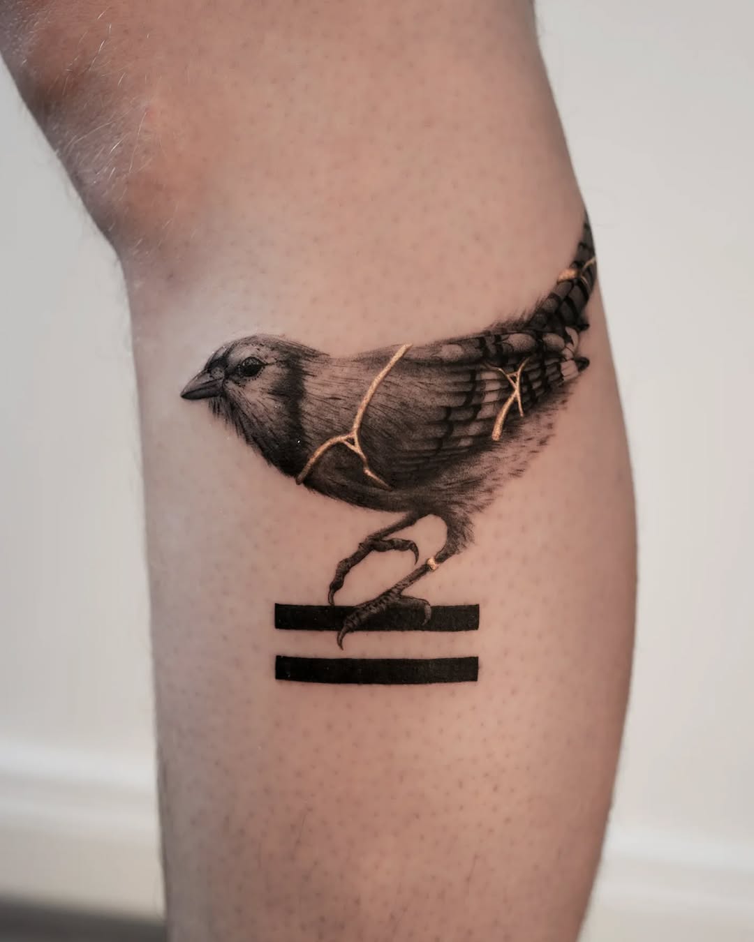 A stunning bird tattoo with kintsugi elements