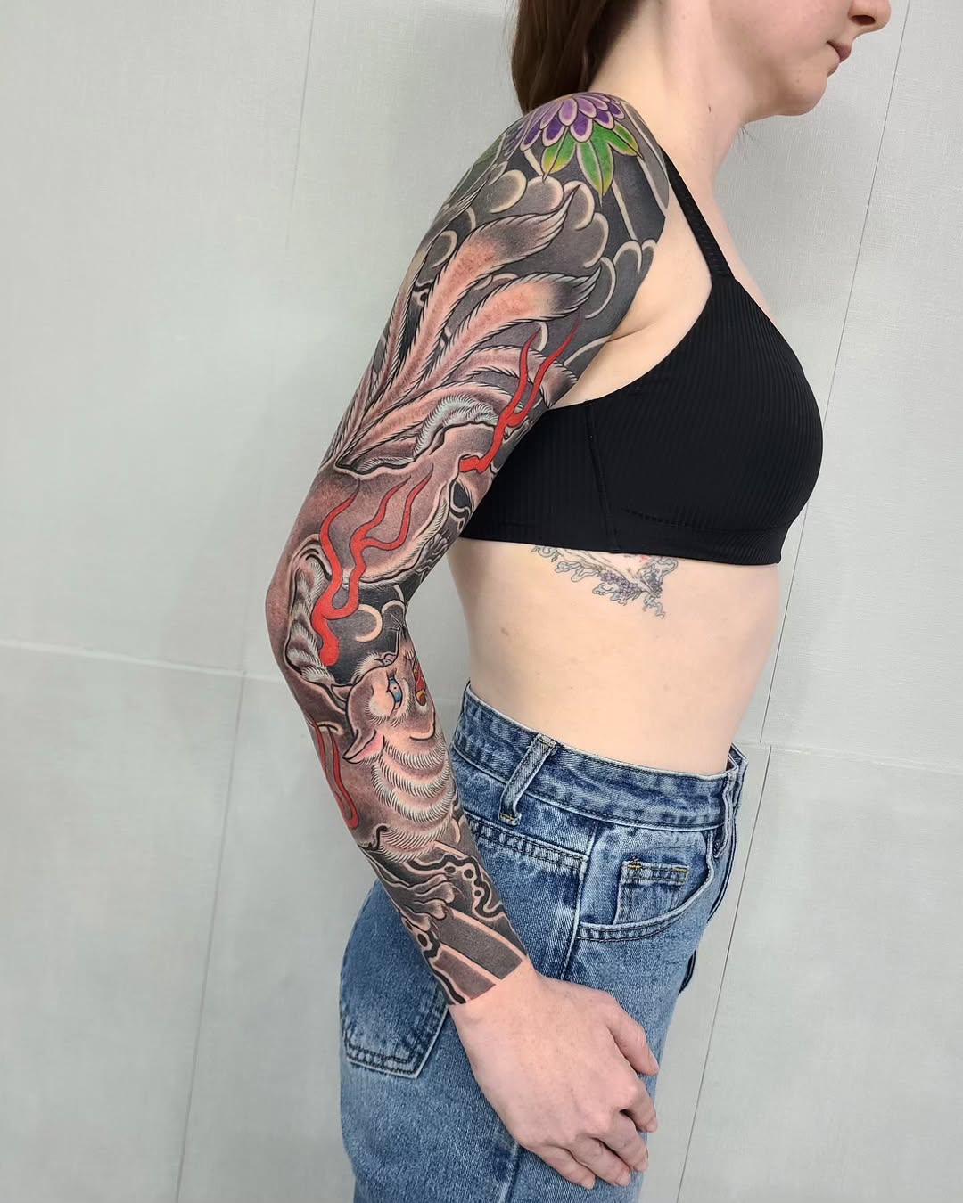 Stunning sleeve tattoo showcasing intricate koi design