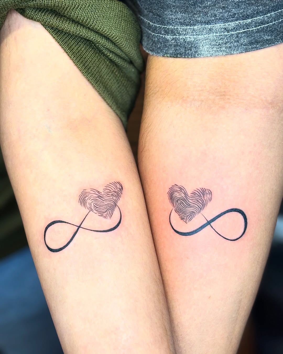 Elegant infinity love tattoos on forearms