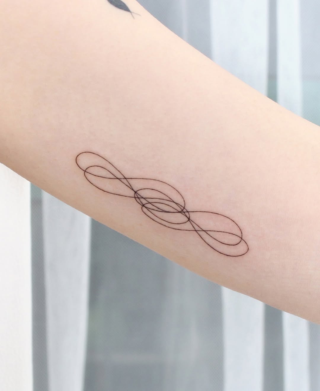 Elegant infinity tattoo with unique line art