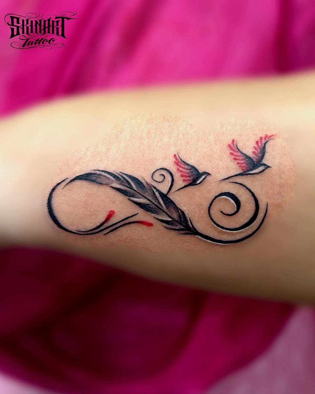 Elegant infinity tattoo with birds and floral details