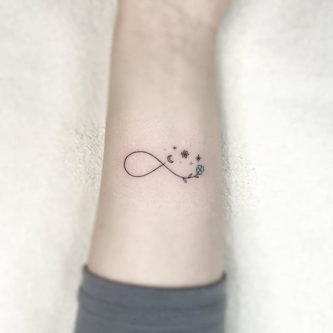Whimsical infinity tattoo with celestial motifs